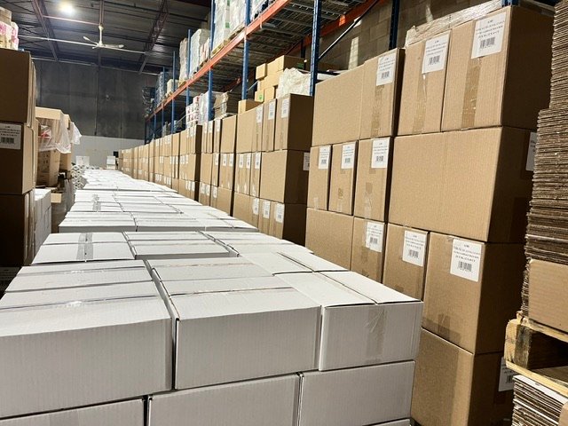 Cased packaging stock lining a warehouse aisle
