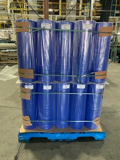 Pallet of blue sheeting film rolls banded for shipment